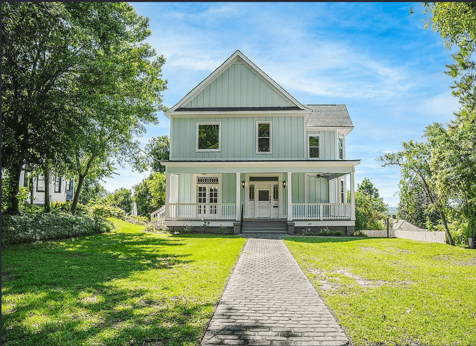 Restored Victorian farmhouse exterior with wraparound porch, an Augusta rental minutes from The Masters